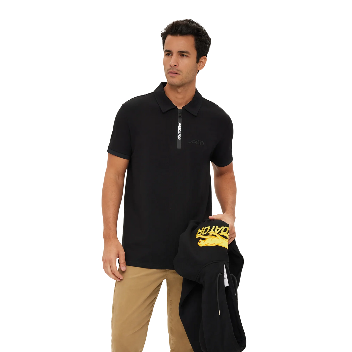 Man wearing a black zipper polo shirt with Predator branding