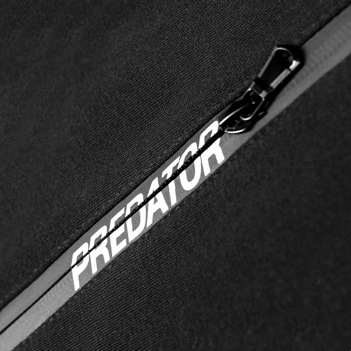 Black Polo Shirt Close-up of Predator Branding in Zipper