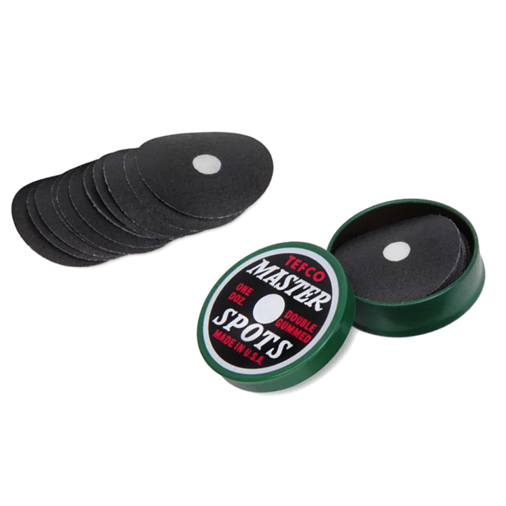 Tefco Master Spots Black Table Spots Fanned Out Beside the Open Green Tin